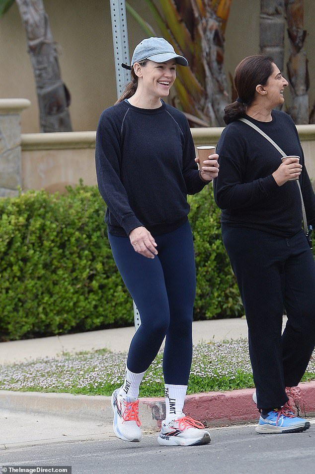 She wore a midnight blue crew neck, navy blue leggings and a sensible cap for a leisurely neighborhood stroll