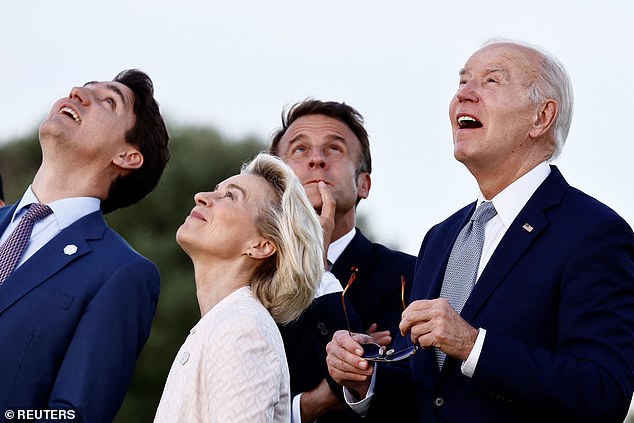 US President Joe Biden, Canadian Prime Minister Justin Trudeau, French President Emmanuel Macron and European Commission President Ursula von der Leyen react during a flag ceremony on the first day of the G7 summit in Savelletri, Italy, June 13, 2024