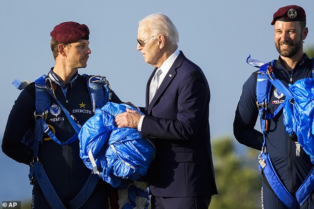 US President Joe Biden greets an Italian Army paratrooper after watching a skydiving demo during the G7 world leaders' summit in Borgo Egnazia, Italy, Thursday, June 13, 2024