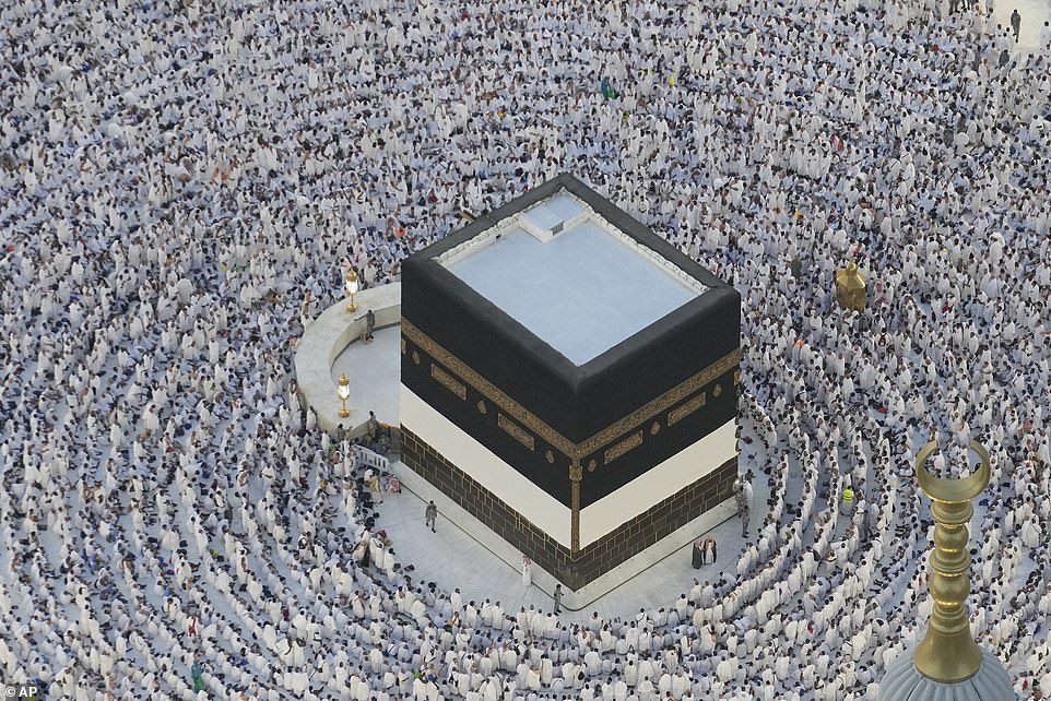 Muslim pilgrims walk around the Kaaba, the cube-shaped building at the Grand Mosque in Mecca
