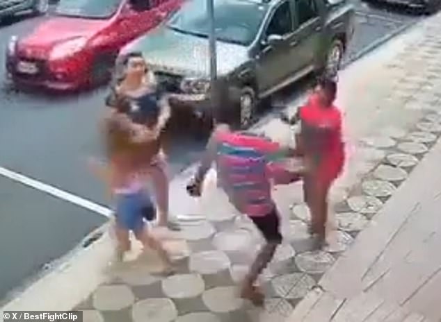 A man (bottom right) reacts violently after seeing a woman (top right) hit a young girl (bottom left) for no reason on the street in Brazil