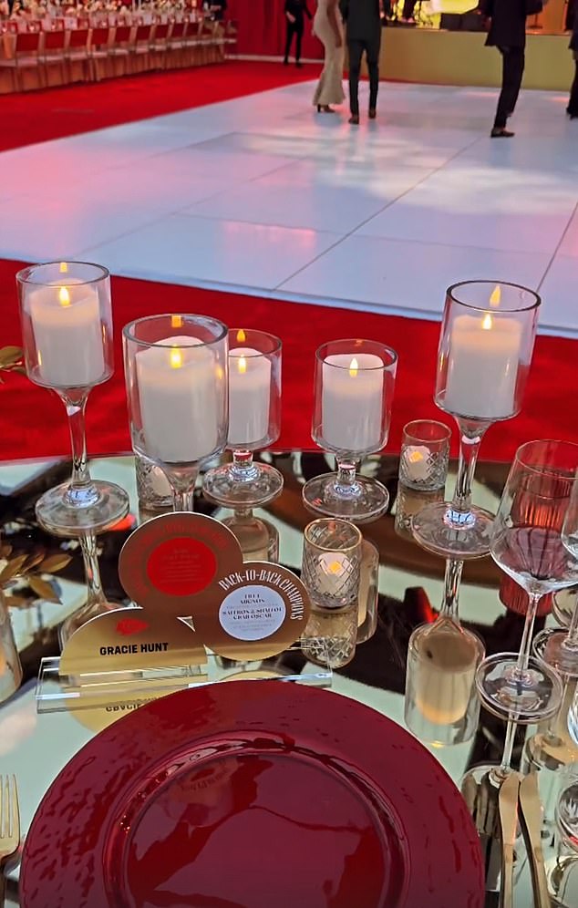 The glamorous soiree featured lots of candles and lots of red details on the tables