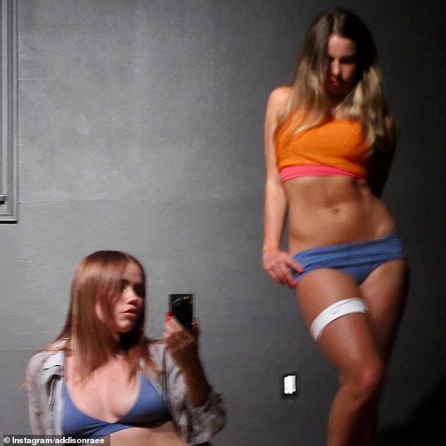 In a blurry follow-up clip, the TikTok dancer showed off her abs while modeling a bright orange sports bra