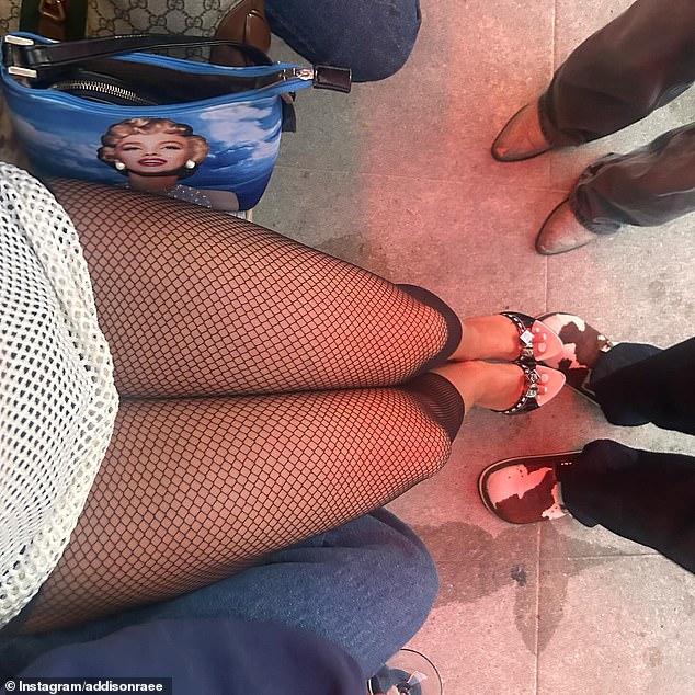 In the final image from her IG slideshow, Addison snapped a photo of just her legs while wearing white mesh shorts and black fishnet leggings.