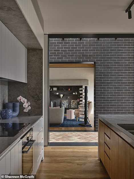 From the front door, a long hallway leads guests down through the original historic home to the expansive common area added to the rear.