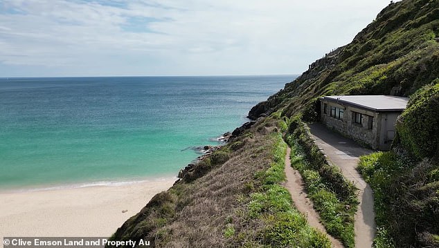 The clifftop cottage is nestled in the cliffs near the famous Minack Theater and overlooks Porthcurno beach in Cornwall