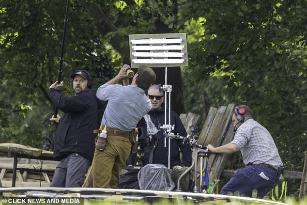 Hugh made a dramatic facial expression as he aimed a hose during the scene while several crew members could be seen nearby