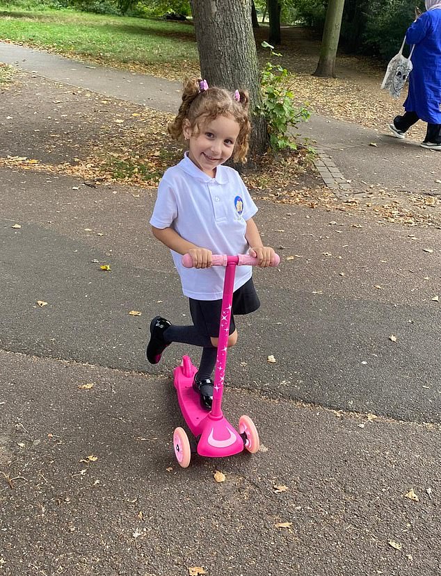 Elena is pictured riding a pink scooter