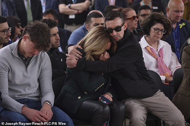 Ian Coates' son Lee Coates hugs Barnaby's mother Emma during Thursday's emotional wake