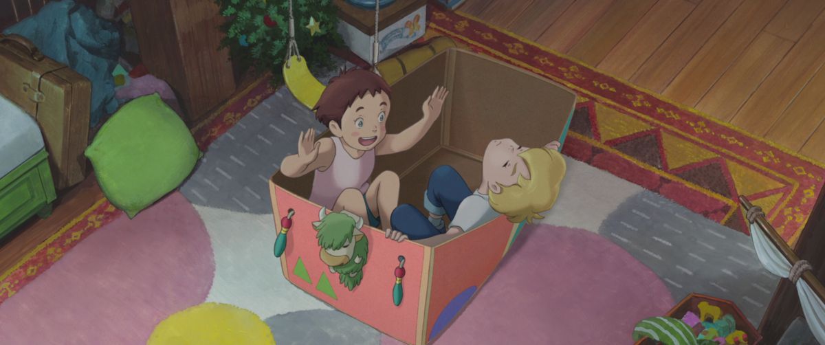 Young girl Amanda gestures enthusiastically as her imaginary friend Rudger slumps back against the side of the pink, decorated cardboard box they are both sitting in, in a scene from Studio Ponoc's anime film The Imaginary 