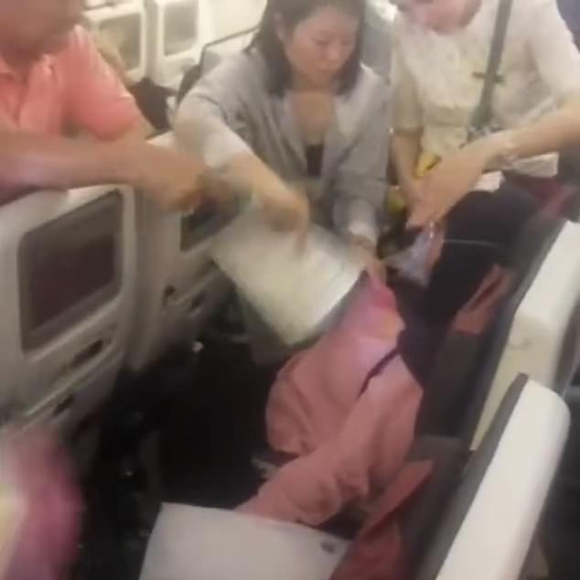 The woman was surrounded by fellow passengers who tried to help her cool down