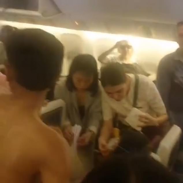 Passengers appeared to use paper bags intended for motion sickness to fan the woman