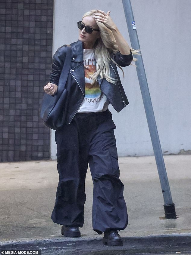 The radio queen, 49, looked effortlessly stylish in an open-zip leather jacket, teamed with a Led Zeppelin band T-shirt, baggy black trousers and matching boots