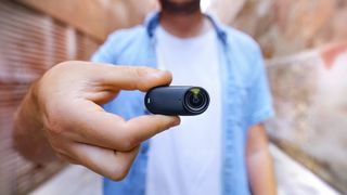 Insta360 Go 3S camera close up with person out of focus