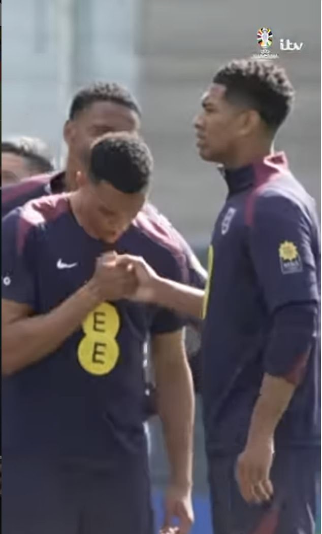 Alexander-Arnold and Bellingham appear to blow on each other's hands during the handshake