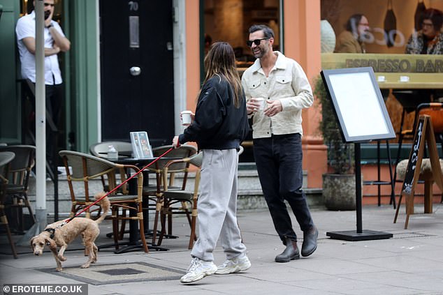 Meanwhile, her mystery companion wore a cream denim jacket, black trousers and sunglasses
