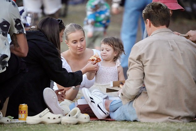 Matt and Annelyse brought a stack of pizzas to the seaside park, while friends brought bags of food and drinks, while Annelyse hand-fed Posy