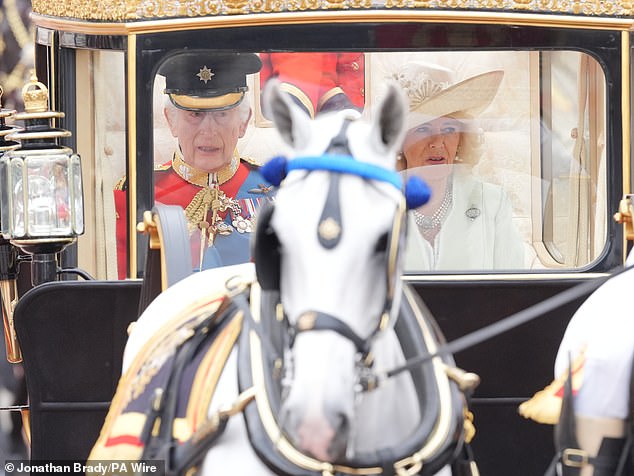 King Charles III and Queen Camilla travel along The Mall to the Trooping the Color ceremony