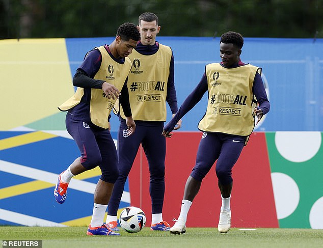 Bukayo Saka (right) takes part in a training exercise alongside Bellingham (left) and Lewis Dunk (centre)