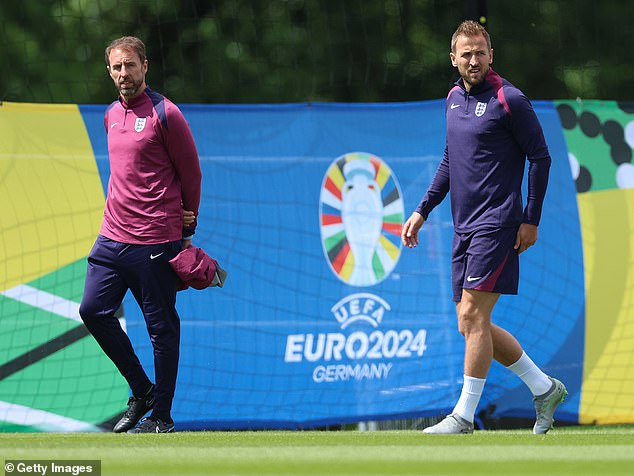 England captain Harry Kane (right) walks closely with Southgate as training continues