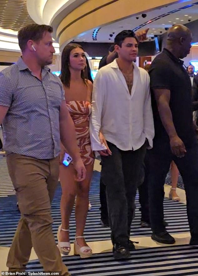 He was seen holding hands with a mystery woman as he walked to his destination in Vegas