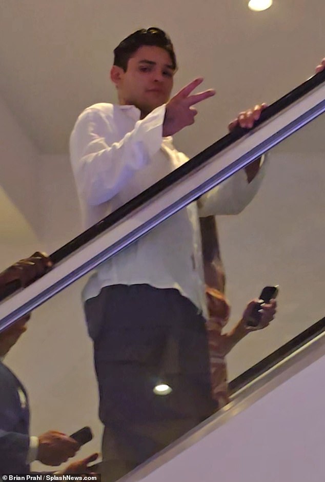 Garcia showed the cameras a peace sign as he rode the escalator at the Fountainbleau hotel