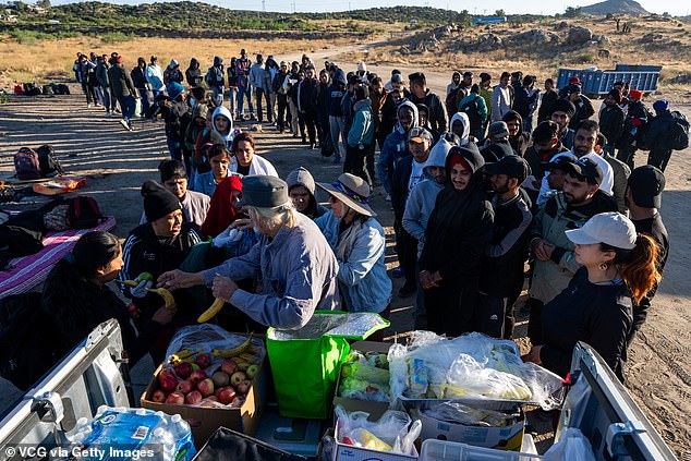 Volunteers distribute food to migrants entering the U.S. from Mexico in Jacumba Hot Springs, California