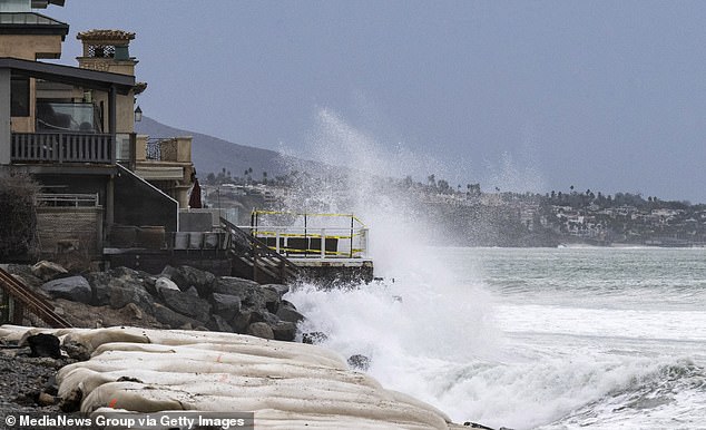 Waves crash into boulders in front of homes on Capistrano Beach in Dana Point, one of the most expensive real estate areas, and areas are hardest hit