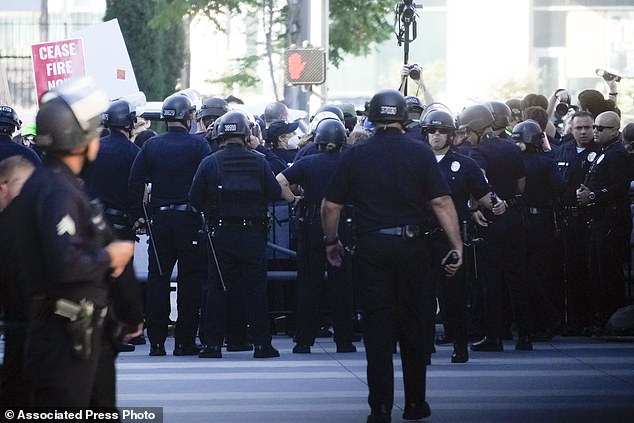 Law enforcement officers responded to protesters near the campaign event