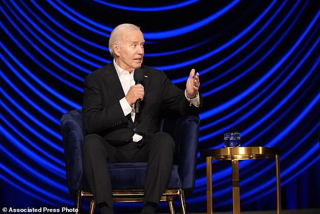 President Joe Biden speaks with former President Barack Obama at a campaign event on Saturday evening