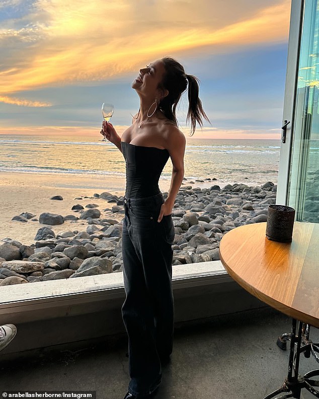 The photos showed Arabella enjoying a glass of wine by a beautiful waterway at sunset and were taken at Rick Shores restaurant