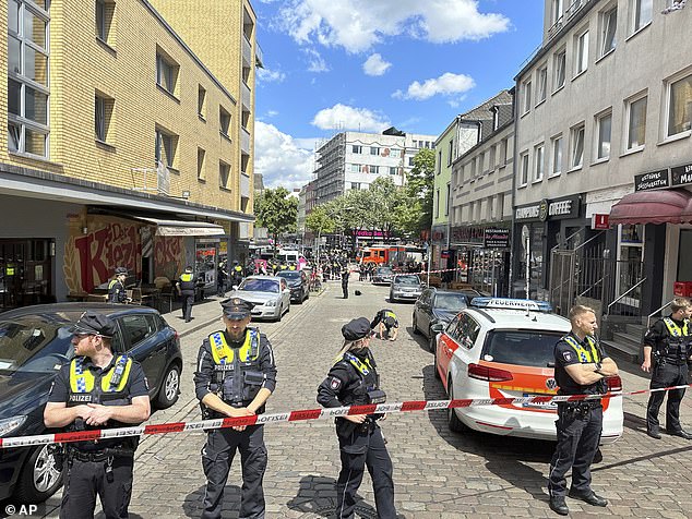 Police cordon off an area near the Reeperbahn in Hamburg after a man allegedly started threatening an officer with an ax