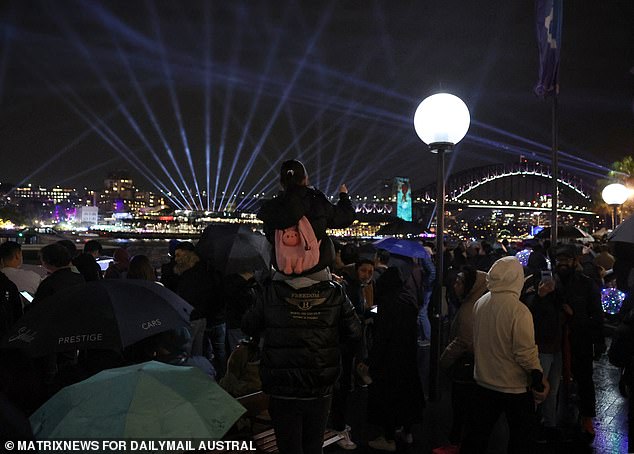 Poor weather conditions were cited by the drone operator as the main reason for the cancellation.  The photo shows crowds of people braving the cold conditions before the show was called off