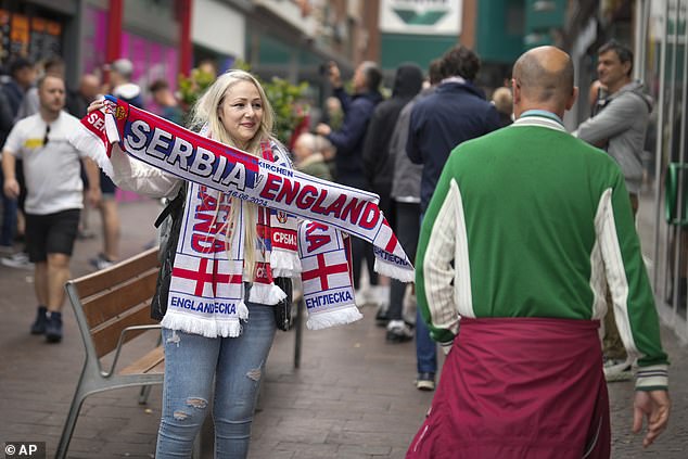 A woman is seen selling scarves in the German city of Gelsenkirchen ahead of tonight's Euro 2024 match between England and Serbia