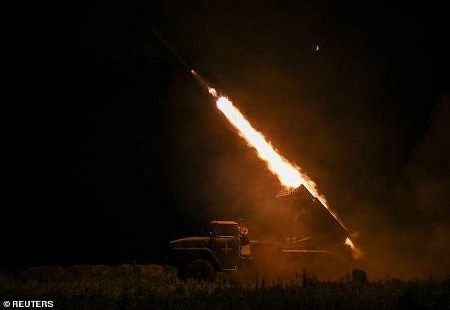 Ukrainian soldiers of the 148th Separate Artillery Brigade of the Ukrainian Air Assault Forces fire a BM-21 Grad multiple rocket system at Russian troops