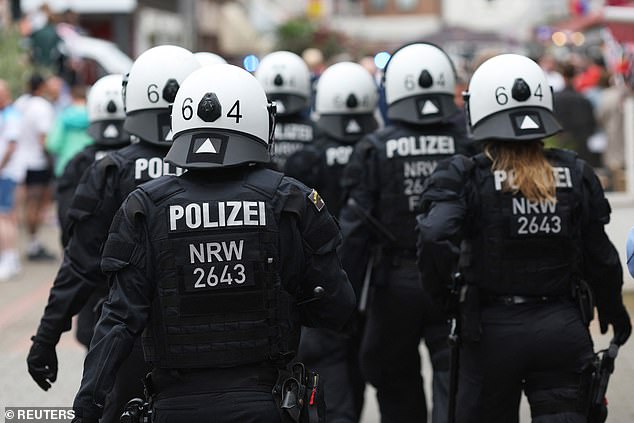 Police officers in riot gear gathered as tensions increased between the English and Serbian fans