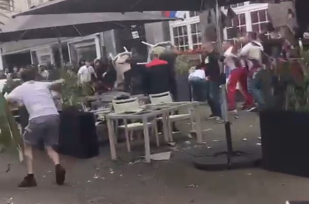 In the city of Gelsenkirchen, rival groups of fans were seen throwing chairs and tables at each other