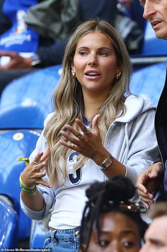 Luke Shaw's partner Anouska Santos was deep in conversation as she waited for the game to start
