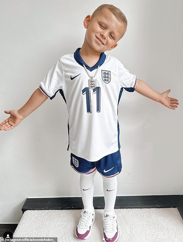 Phil Foden's son Ronnie Foden (pictured) looked adorable wearing a full England kit and matching necklace