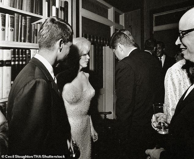 The only known photo of Marilyn with both Bobby, left, and JFK, taken at a reception after her Garden performance.
