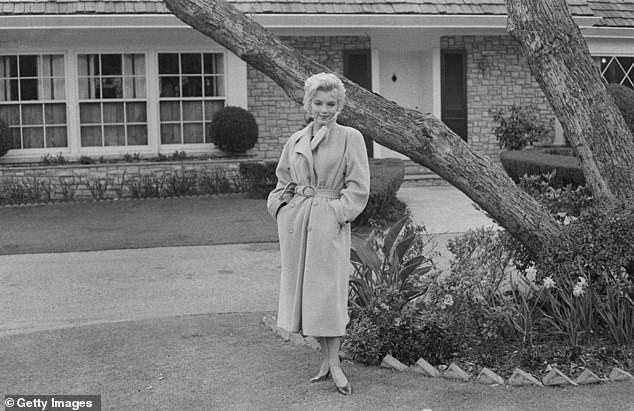 Monroe poses in front of her house in 1962, it was the only property she ever purchased and owned