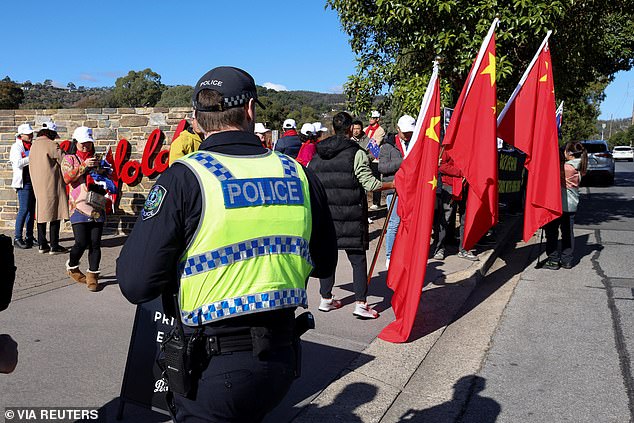 At one point, a scuffle broke out when a man fell to the ground and downed a raised loudspeaker as a heavy police presence observed the standoff.