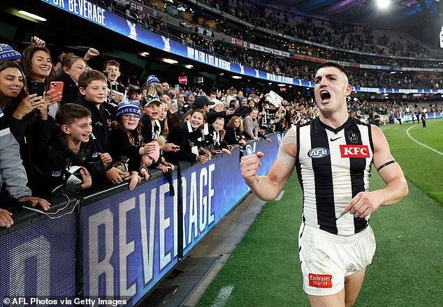 The Collingwood star celebrates with fans after the thrilling win against the Kangaroos