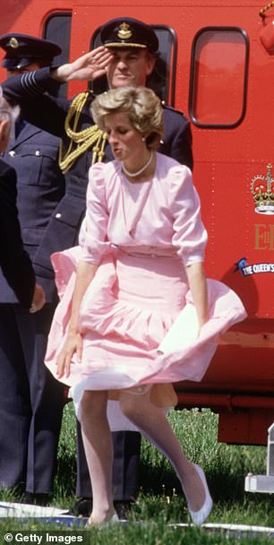 Princess Diana's skirt is blown up by a gust of wind after a helicopter flight in 1985