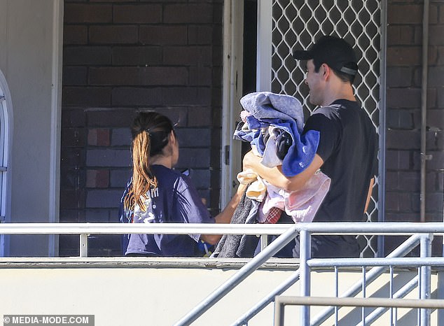 Another photo showed them entering James' house with their arms full of laundry