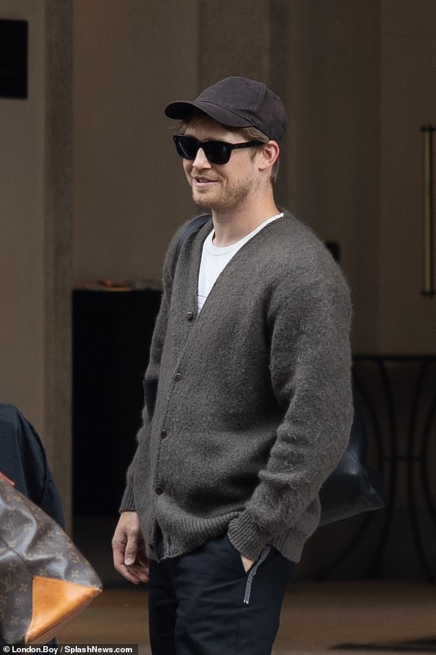 The actor shielded his face with a baseball cap and sunglasses as he arrived at his hotel and chatted with a group of people outside
