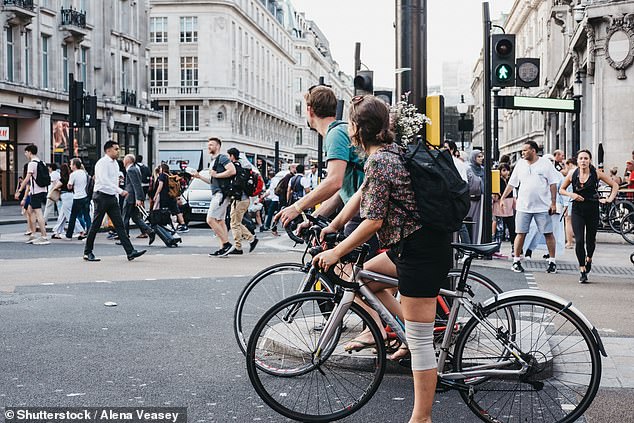 Currently, wearing a helmet while cycling in Britain is not currently required by law.  Pictured here are cyclists waiting for traffic to change in London