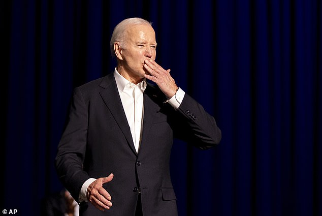 President Joe Biden shares a kiss as he arrives for a campaign event with former President Barack Obama, moderated by Jimmy Kimmel