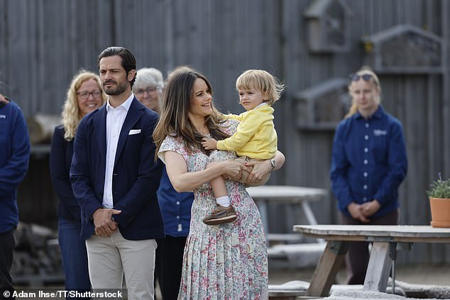 Princess Sofia, who wore a floral top and matching skirt for the occasion, looked proud of her youngest son as she held him in her arms