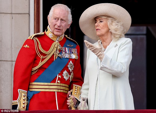 Lip reader Juliet Sullivan says King Charles (pictured with Queen Camilla) commented on the 'stunning' view as he stepped onto the balcony